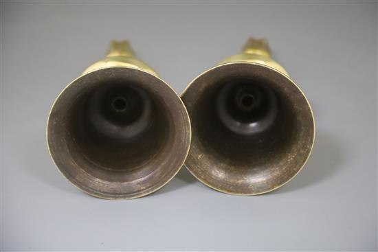 A pair of 17th century Ottoman brass bell based candlesticks, H.9in.